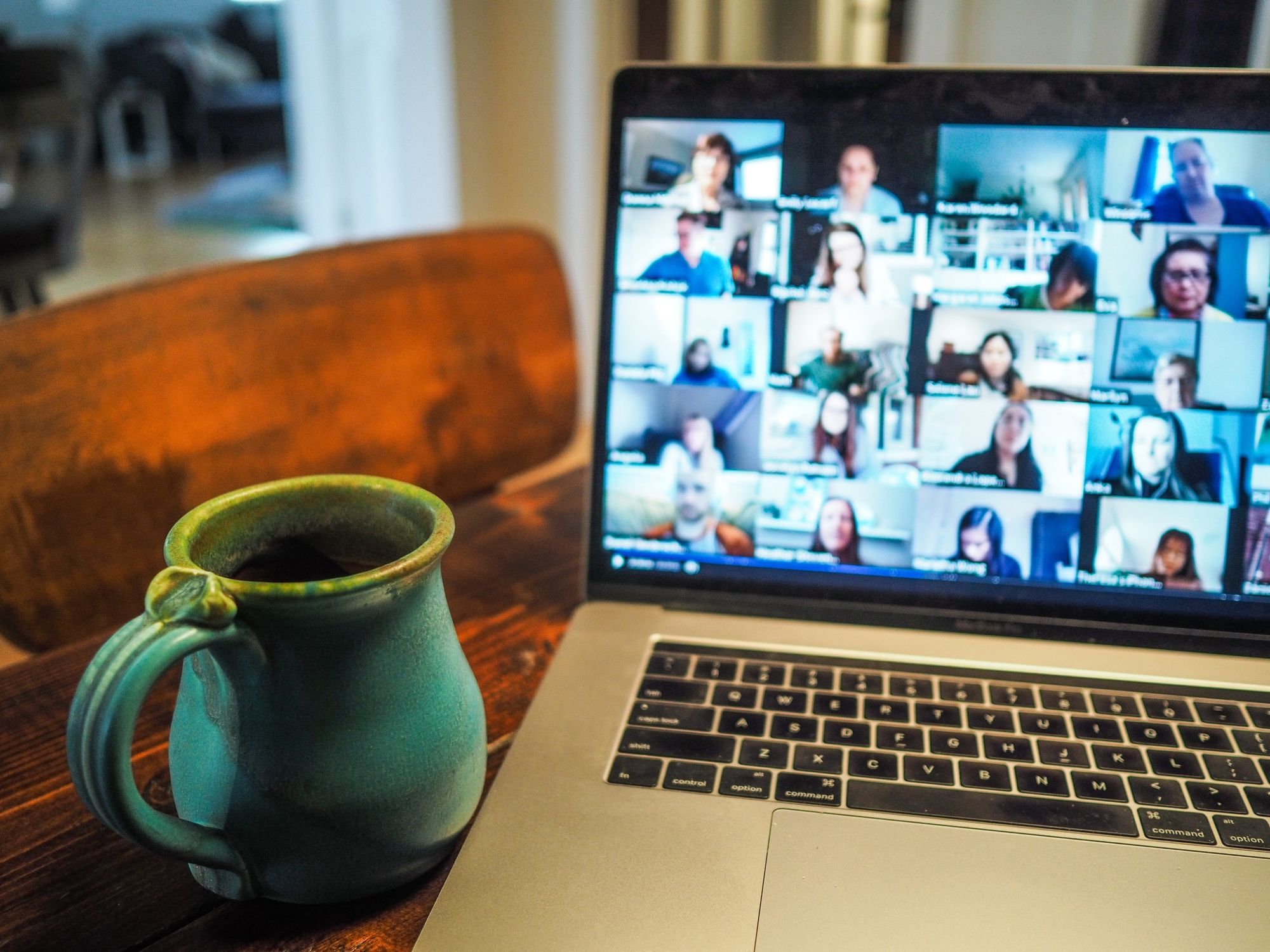 laptop with Zoom screen next to mug_team building activities for work_flok